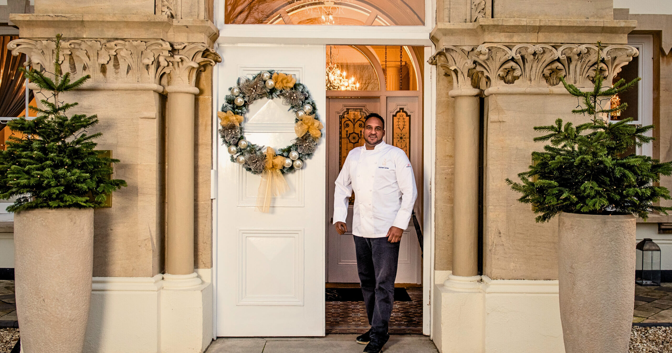 42934638-98fe-4b97-b6cf-29f749931775 Michael Caines MBE standing in front of Lympstone Manor
