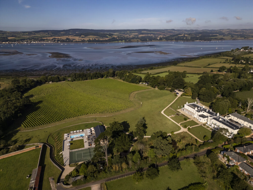 Lympstone Manor Hotel and Estate with Pool House Restaurant and a view of the Exe Estuary.