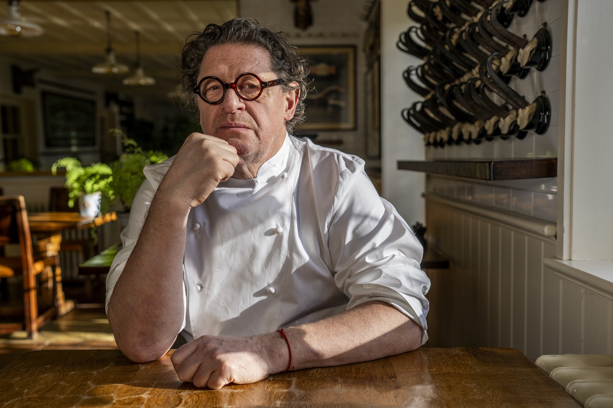 Image of Marco Pierre White sat at a restaurant table