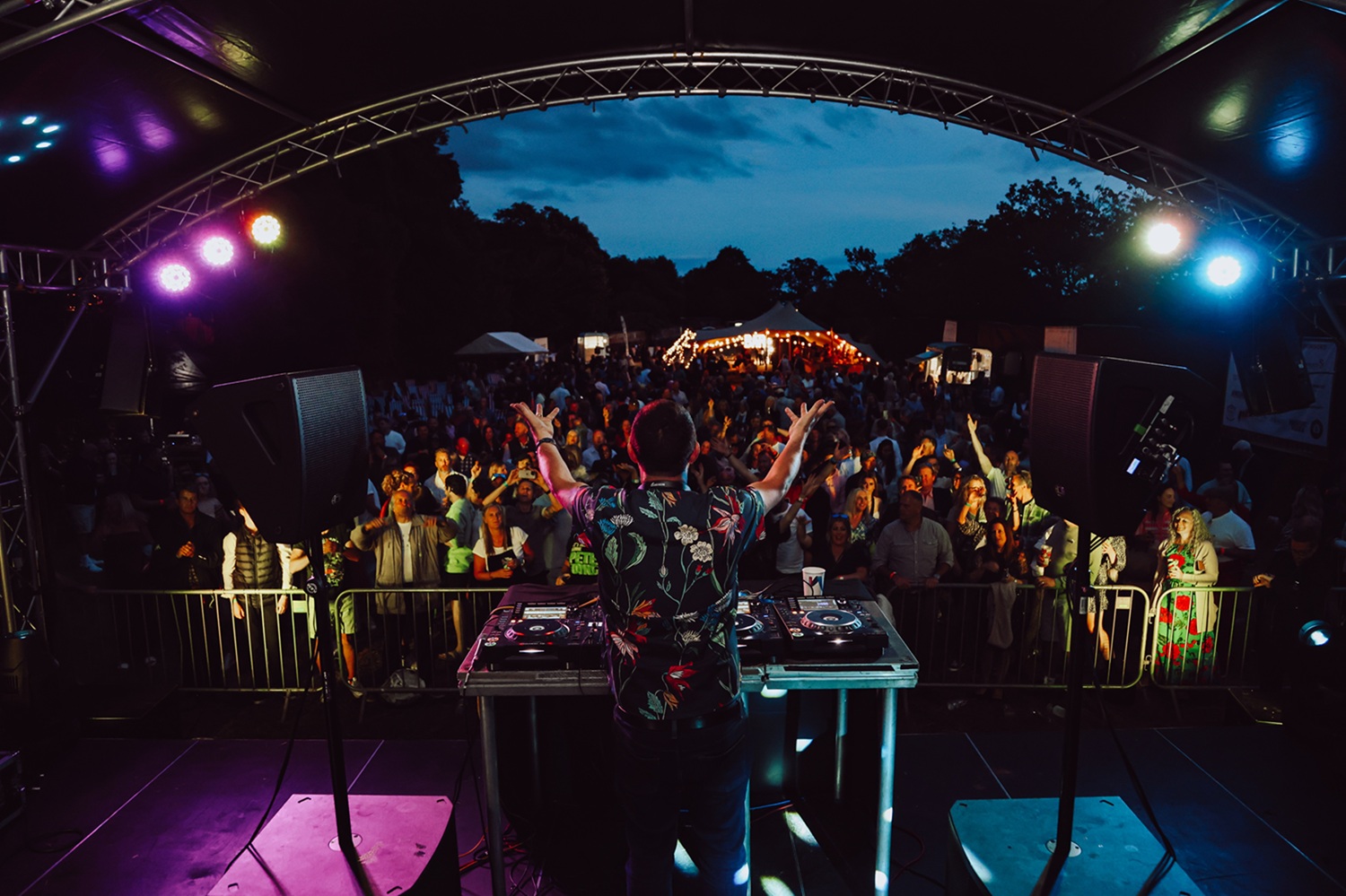 Judge Jules DJ set at Celebration of Speed 2023 with view of stage, audience and festival bar.
