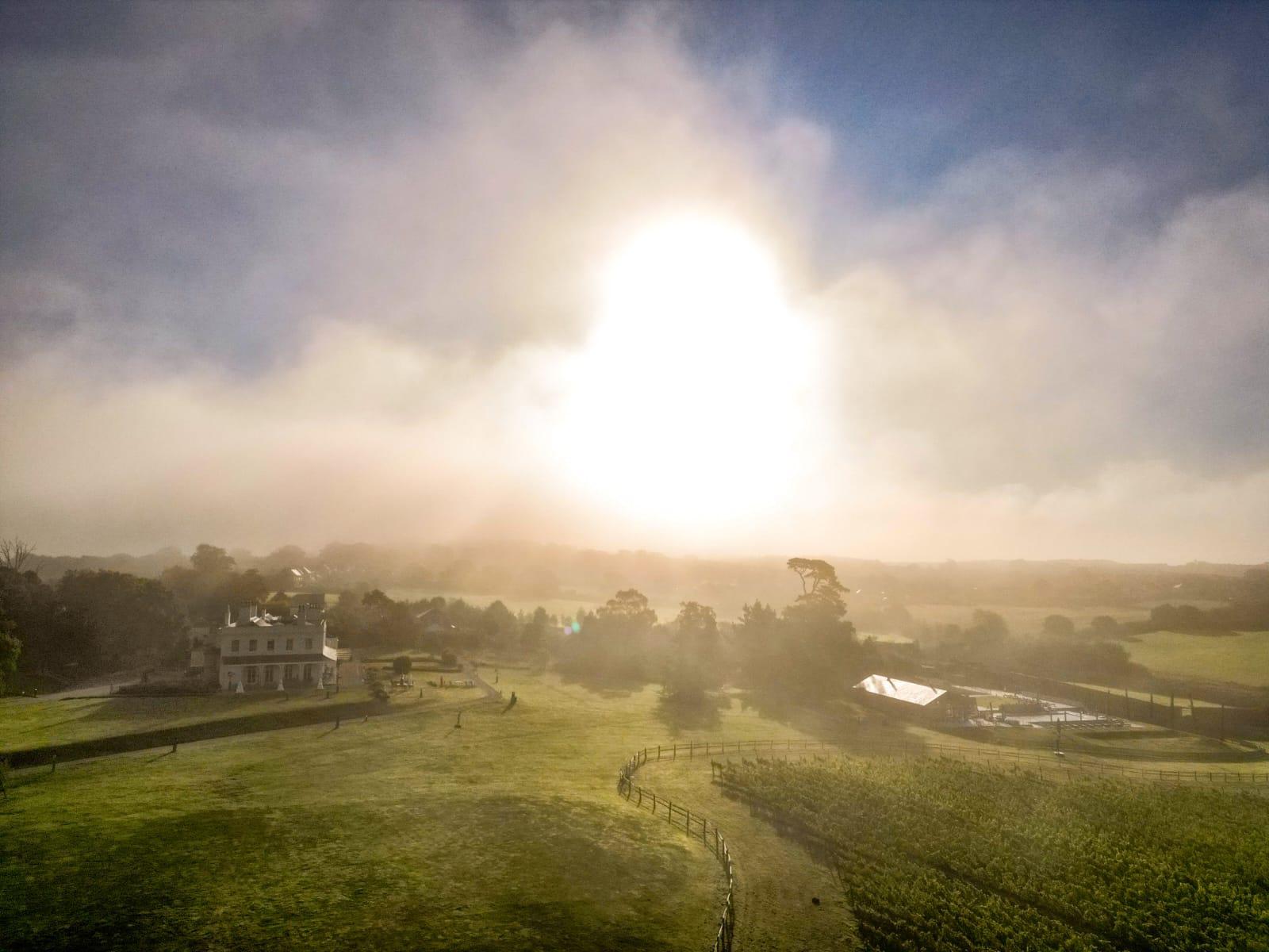 Lympstone Manor at sunrise on a foggy morning