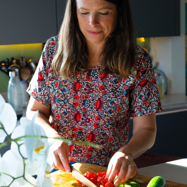Hannah from Purely Nourishing in the kitchen preparing a meal