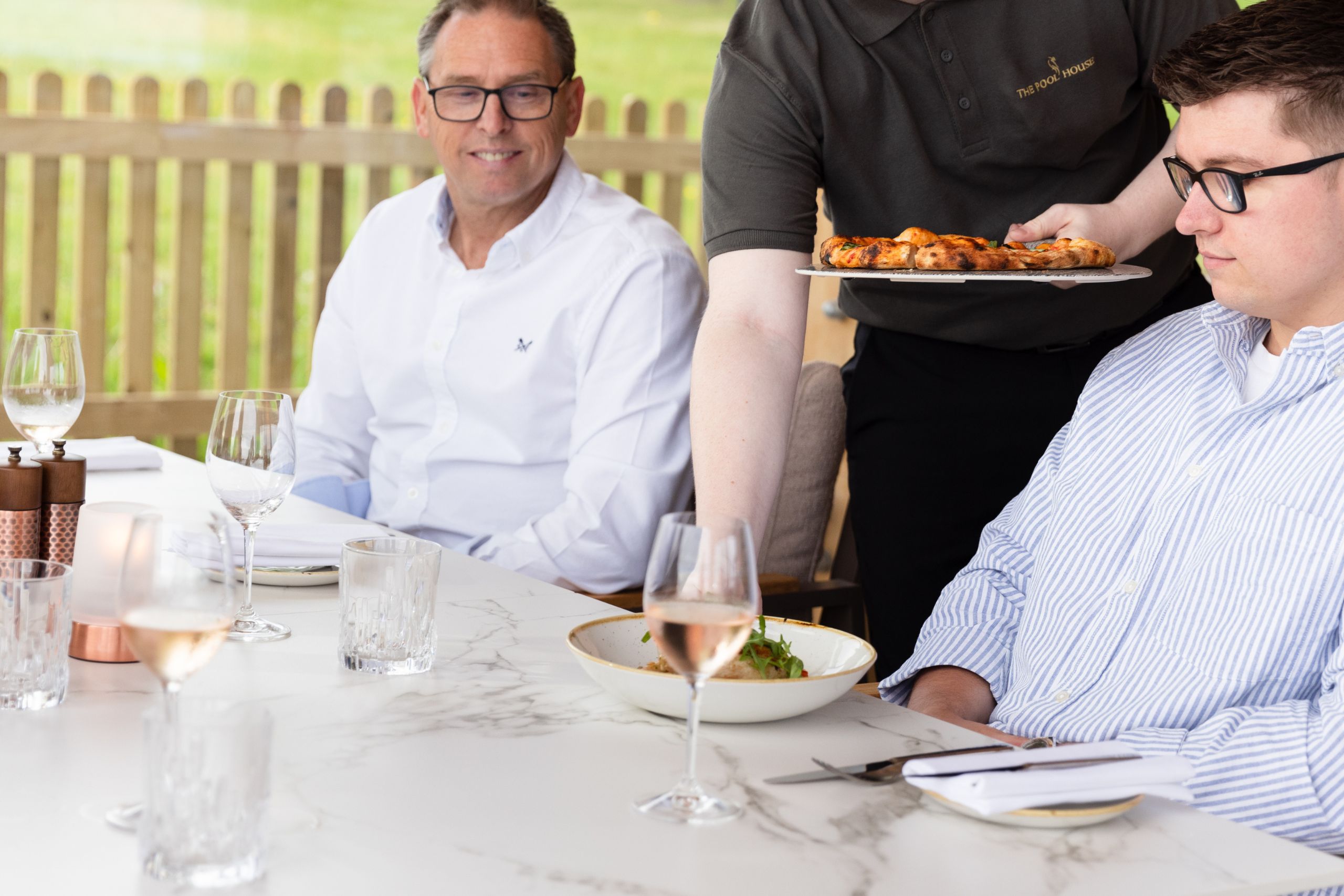 Family enjoying Father's Day lunch in the Pool House