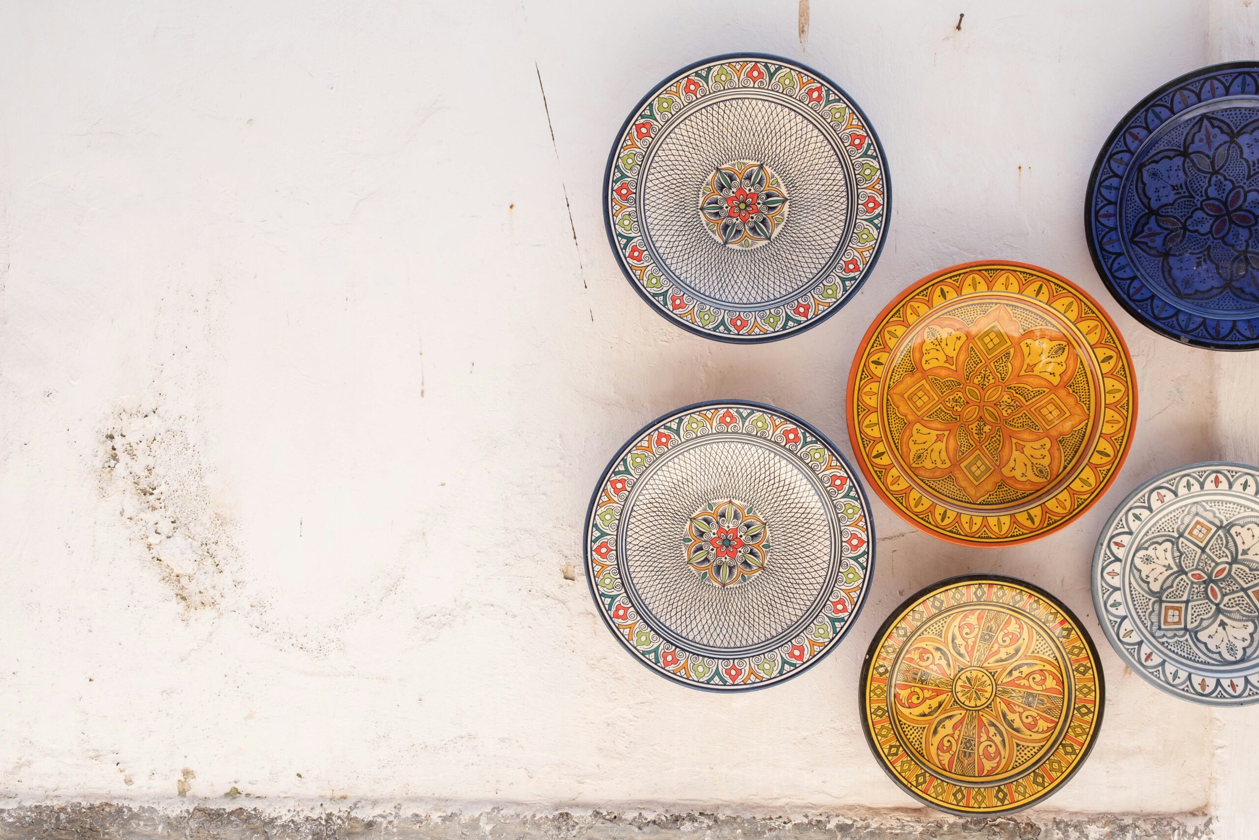 Moroccan plates displayed on a white wall