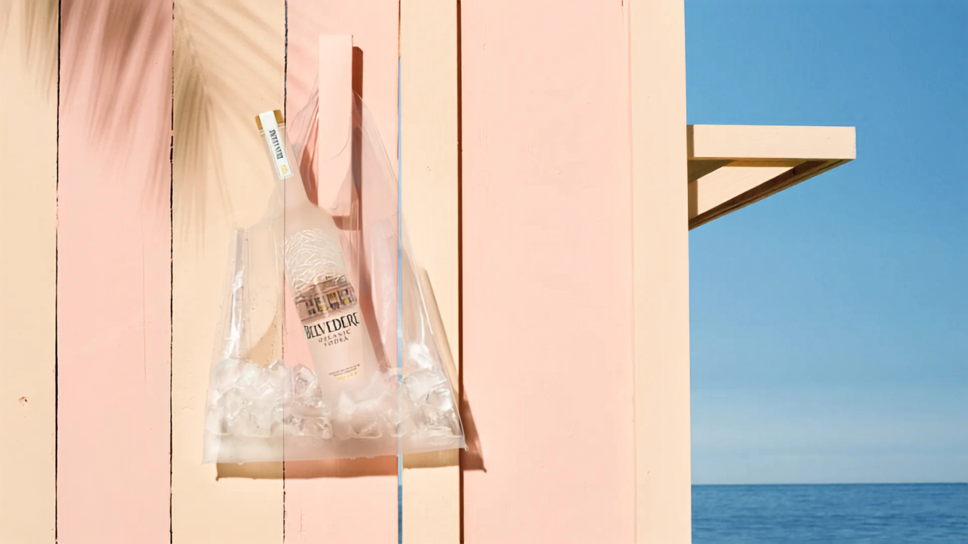 Belvedere Organic Vodka in front of a pink beach hut