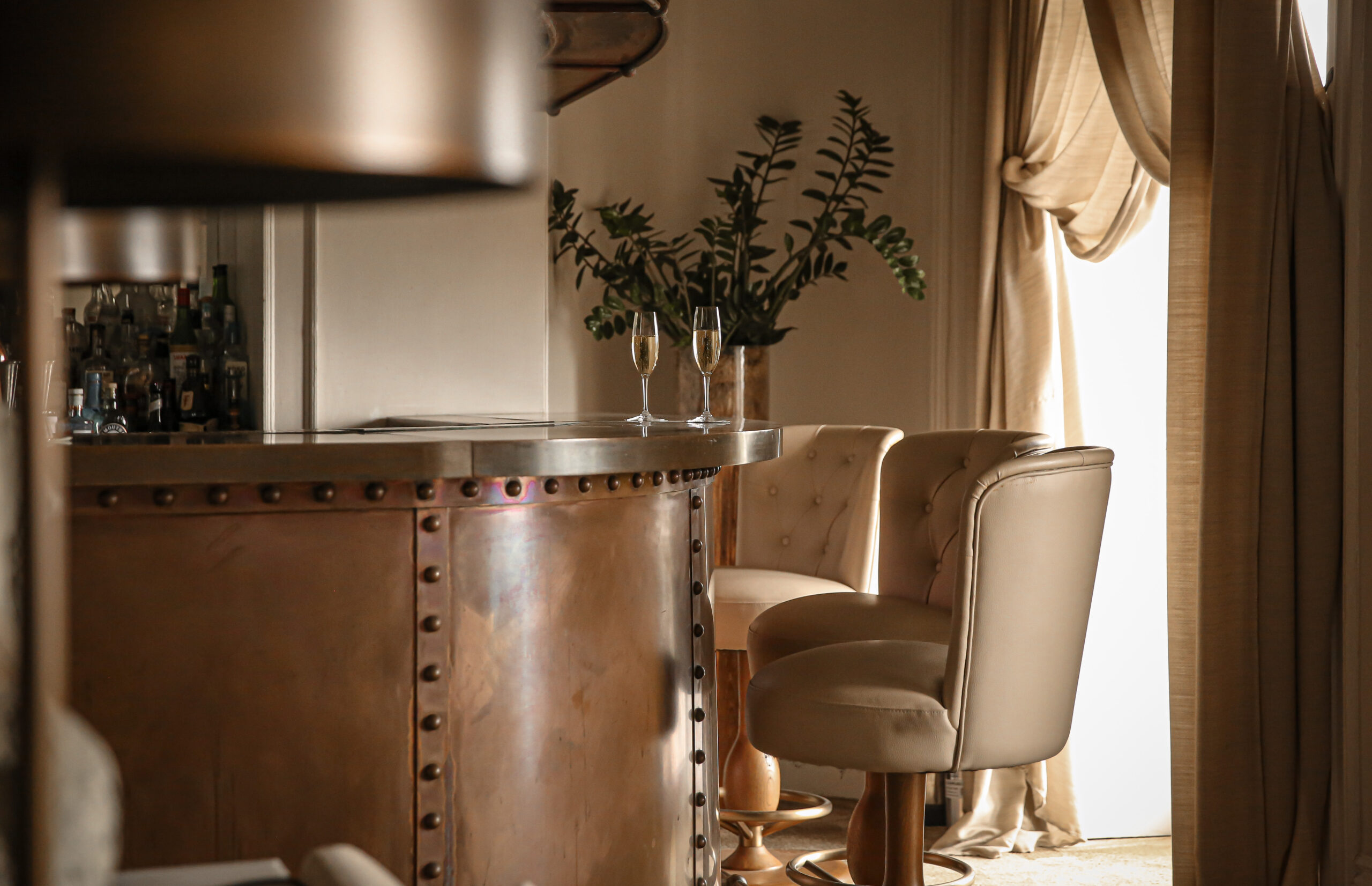 Lympstone Manor Bar featuring bar, bar stools and window overlooking the estate