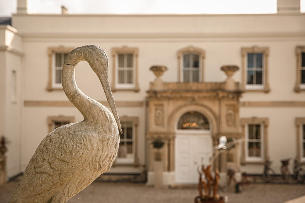 Lympstone Manor Hotel with Heron sculpture in the foreground