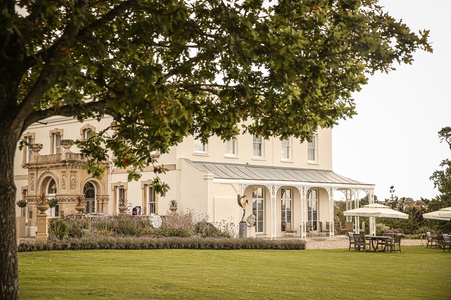 Lympstone Manor in the autumn with trees in the foreground